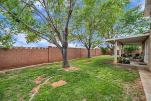 Fenced backyard with a patio