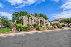 Mediterranean / spanish home featuring stucco siding, an attached garage, and driveway