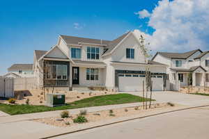 View of front of house with concrete driveway, stucco siding, covered porch, and roof with shingles
