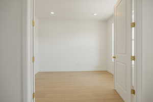 Hall featuring light wood-style flooring and recessed lighting