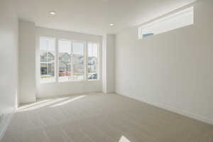 Spare room featuring carpet, recessed lighting, and a residential view