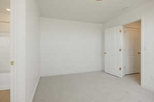 Unfurnished room with light carpet