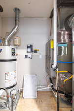 Utility room with strapped water heater and heating unit