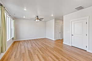 Unfurnished room featuring a ceiling fan, light wood finished floors, and recessed lighting
