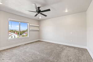 Spare room featuring light colored carpet, recessed lighting, and a ceiling fan