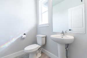 Half bathroom featuring baseboards and tile patterned floors