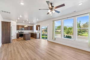 Kitchen featuring light countertops, appliances with stainless steel finishes, recessed lighting, pendant lighting, and open floor plan
