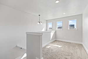 Spare room with light colored carpet and recessed lighting