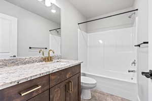 Full bath with shower / washtub combination, vanity, and light tile patterned floors
