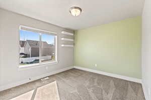 Empty room with carpet floors and baseboards