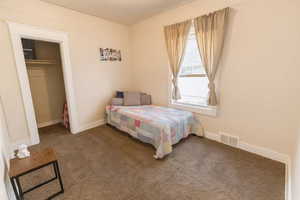 Bedroom featuring carpet and a closet