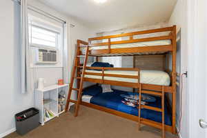 Carpeted bedroom with cooling unit