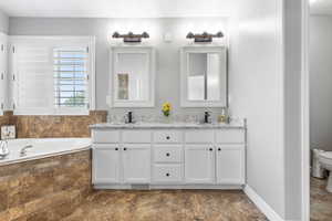 Bathroom with a bath and double vanity
