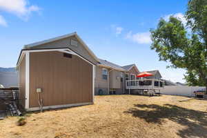 Back of property with a deck