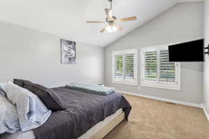 Bedroom with lofted ceiling, carpet, and a ceiling fan