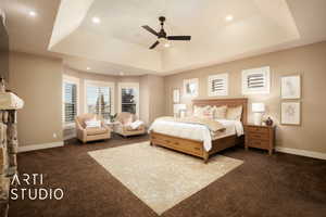 Bedroom with a raised ceiling, dark carpet, a ceiling fan, and recessed lighting