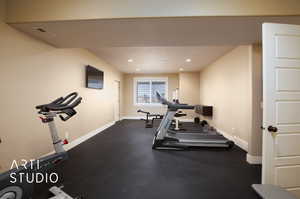 Exercise room with baseboards and recessed lighting