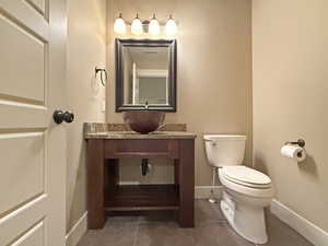 Half bath featuring vanity and tile patterned flooring