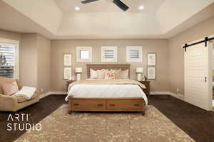 Bedroom featuring a barn door, carpet, a tray ceiling, and a ceiling fan