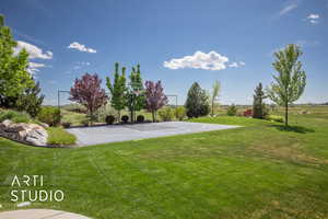 View of basketball court with community basketball court and a lawn