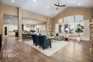 Living area featuring high vaulted ceiling, plenty of natural light, recessed lighting, light wood-style floors, and a ceiling fan