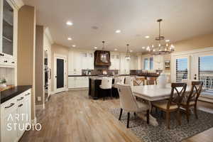 Dining area featuring a chandelier, recessed lighting, and light wood-type flooring