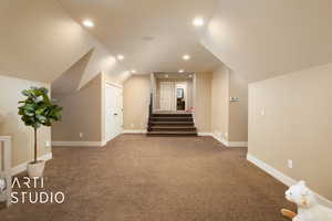 Additional living space featuring stairway, carpet, lofted ceiling, and recessed lighting