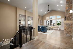 Stairs featuring high vaulted ceiling, recessed lighting, wood finished floors, and ceiling fan