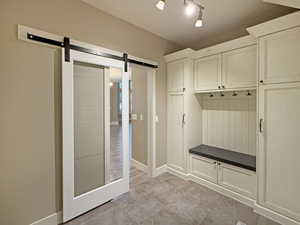 Mudroom with baseboards and a barn door