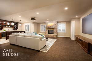 Living room featuring wet bar, dark colored carpet, recessed lighting, beverage cooler, and a fireplace