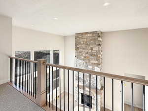 Hall featuring a textured ceiling, recessed lighting, and carpet