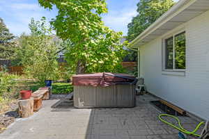 View of patio with a hot tub