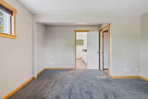 Spare room featuring baseboards and light carpet