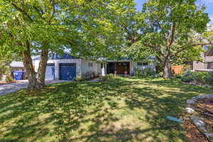 View of front of property with driveway, an attached garage, and stucco siding
