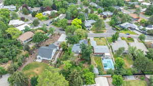 Aerial view of property and surrounding area with nearby suburban area