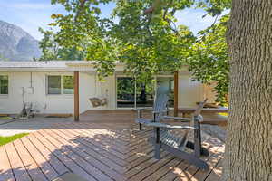 Wooden deck with a mountain view and a patio area