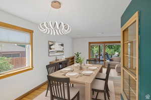 Dining area with light wood-style flooring and healthy amount of natural light