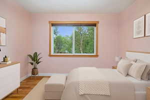 Bedroom featuring light wood-type flooring and baseboards