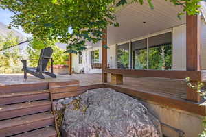 Deck featuring a jacuzzi and a mountain view