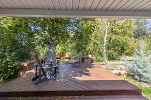 Wooden deck featuring view of wooded area