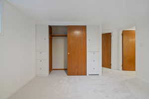 Unfurnished bedroom featuring carpet and a closet