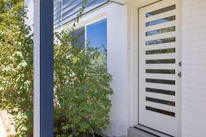 Doorway to property featuring brick siding