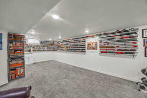 Rec room featuring light carpet and baseboards