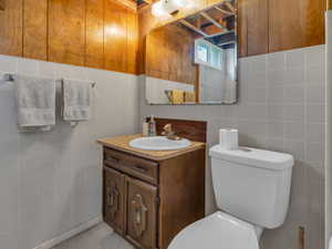 Bathroom with vanity and tile walls