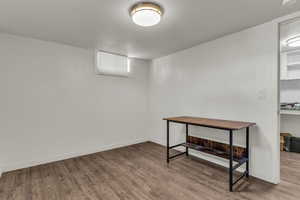 Basement featuring wood finished floors and a textured ceiling
