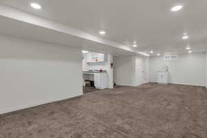 Finished basement featuring dark colored carpet and recessed lighting
