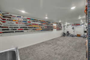 Exercise area with carpet flooring and recessed lighting