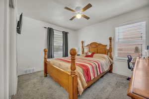 Bedroom with light carpet and a ceiling fan