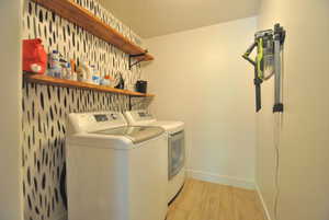 Laundry area featuring light wood-type flooring