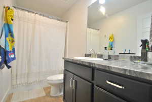 Full bathroom with vanity and light wood-style flooring